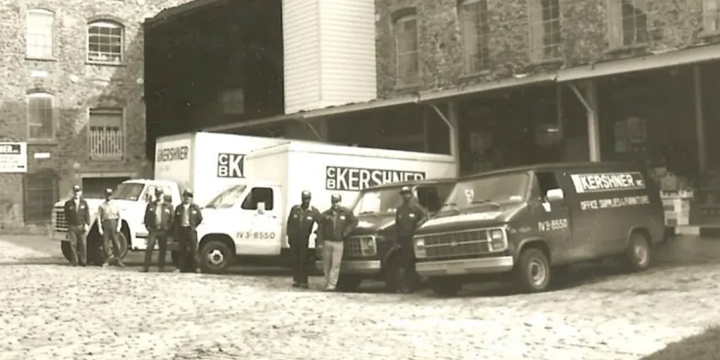 Vintage photo of the CB Kershner family business delivery trucks and crew